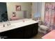 Bathroom with a vanity, sink, mirror, pink accents, toilet, and a shower with a pink floral curtain at 1718 S 82Nd Way, Mesa, AZ 85209