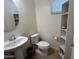 Cozy powder room featuring a pedestal sink, tile flooring and modern fixtures at 1718 S 82Nd Way, Mesa, AZ 85209
