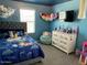 Cozy bedroom featuring blue walls, a queen bed and matching accents at 1718 S 82Nd Way, Mesa, AZ 85209