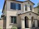 Charming two-story home featuring a stucco exterior, arched entryway and decorative window shutters at 1718 S 82Nd Way, Mesa, AZ 85209