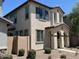 Beige two-story home featuring a stylish front porch and well-manicured landscaping at 1718 S 82Nd Way, Mesa, AZ 85209