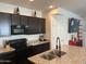 Modern kitchen featuring granite countertops, stainless steel appliances, and dark wood cabinetry at 1718 S 82Nd Way, Mesa, AZ 85209
