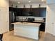 Modern kitchen with dark cabinets, stainless steel appliances and a granite island at 1718 S 82Nd Way, Mesa, AZ 85209