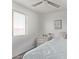 Cozy bedroom with neutral color palette, wood-look floors, and sunny window at 18555 N 114Th Ave, Surprise, AZ 85378