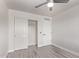 A clean, bright bedroom features hardwood floors, closet, and ceiling fan at 18555 N 114Th Ave, Surprise, AZ 85378