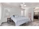 Bright bedroom features modern ceiling fan, wood floors, and ensuite bathroom access at 18555 N 114Th Ave, Surprise, AZ 85378