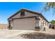 Spacious two-car garage with a wide driveway and attractive exterior at 18555 N 114Th Ave, Surprise, AZ 85378