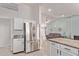 Open kitchen with stainless steel refrigerator and granite counters that flow into the living room at 18555 N 114Th Ave, Surprise, AZ 85378