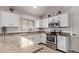 Well-equipped kitchen with white cabinets, stainless steel appliances, and granite countertops at 18555 N 114Th Ave, Surprise, AZ 85378