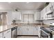 Kitchen features granite countertops, stainless steel appliances, and white cabinets for modern appeal at 18555 N 114Th Ave, Surprise, AZ 85378