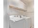 Functional laundry room with a white washer and dryer, and overhead storage cabinets at 18555 N 114Th Ave, Surprise, AZ 85378