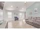 Comfortable living room showcasing a neutral color palette, tile floors, and large windows at 18555 N 114Th Ave, Surprise, AZ 85378