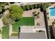 An aerial view showcases a pristine backyard with a pool, patio, and manicured landscaping at 18823 N 97Th Ln, Peoria, AZ 85382