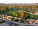 Aerial view of a neighborhood showcasing tree-lined streets and a beautiful golf course nearby at 18823 N 97Th Ln, Peoria, AZ 85382