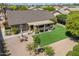 Aerial view featuring a charming home with a manicured backyard, outdoor seating area, and well-kept landscaping at 18823 N 97Th Ln, Peoria, AZ 85382
