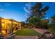 Cozy backyard featuring a covered patio with string lights and a well-maintained grassy area at 18823 N 97Th Ln, Peoria, AZ 85382