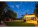 Expansive backyard with pergola-covered patio, lush lawn, and mature landscaping, ideal for relaxation at 18823 N 97Th Ln, Peoria, AZ 85382