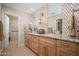 Elegant bathroom with double vanity, granite counters, mosaic tile backsplash and walk-in shower at 18823 N 97Th Ln, Peoria, AZ 85382