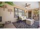 Inviting covered patio with cozy seating, ceiling fan, and decorative accents, perfect for relaxing at 18823 N 97Th Ln, Peoria, AZ 85382
