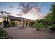 Inviting home exterior with a well-manicured backyard featuring a covered patio and desert landscaping at 18823 N 97Th Ln, Peoria, AZ 85382