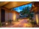 Inviting front entrance with warm lighting, a tiled walkway, and lush desert landscaping at 18823 N 97Th Ln, Peoria, AZ 85382