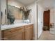 Hallway featuring wood cabinets with a white counter, stylish decor and neutral paint at 18823 N 97Th Ln, Peoria, AZ 85382