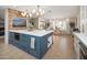 Open kitchen with a large island, barstool seating, views of the dining area, stainless steel appliances and modern design at 18823 N 97Th Ln, Peoria, AZ 85382