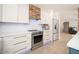Bright kitchen features white cabinets, stainless steel appliances, and a stylish backsplash, creating a modern culinary space at 18823 N 97Th Ln, Peoria, AZ 85382