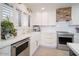 Bright kitchen with white countertops, stainless steel appliances, farmhouse sink and a modern design at 18823 N 97Th Ln, Peoria, AZ 85382