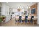 Bright kitchen featuring white cabinetry, a blue island, and wood accent wall at 18823 N 97Th Ln, Peoria, AZ 85382