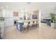 Open-concept kitchen boasts a large island with seating, designer lighting, and seamless flow into the living area at 18823 N 97Th Ln, Peoria, AZ 85382