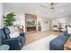 Inviting living room with cozy seating, a wood accent wall, and an electric fireplace at 18823 N 97Th Ln, Peoria, AZ 85382