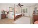 Comfortable bedroom with four-poster bed, neutral colored walls and light colored tile flooring at 18823 N 97Th Ln, Peoria, AZ 85382