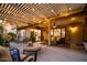 Inviting covered patio with stylish furniture, ceiling fan, and lush greenery, ideal for outdoor living at 18823 N 97Th Ln, Peoria, AZ 85382