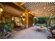 Relaxing covered patio with comfortable seating, string lights, and view of landscaped backyard at 18823 N 97Th Ln, Peoria, AZ 85382
