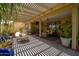 Inviting outdoor patio with comfortable seating, pergola, and vibrant plants, ideal for leisure at 18823 N 97Th Ln, Peoria, AZ 85382