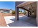 Covered back patio with a fan provides a comfortable outdoor living space with expansive paved area at 18868 E Canary Way, Queen Creek, AZ 85142