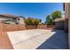 Large backyard with a paved patio area, surrounded by a brick wall and gravel, perfect for outdoor activities at 18868 E Canary Way, Queen Creek, AZ 85142