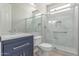 Modern bathroom with glass enclosed shower, tile and blue vanity at 18868 E Canary Way, Queen Creek, AZ 85142