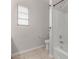 Bathroom featuring a tub shower and toilet with tiled flooring and window at 18868 E Canary Way, Queen Creek, AZ 85142