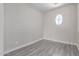 Bedroom with wood-look flooring, a small window, and neutral paint at 18868 E Canary Way, Queen Creek, AZ 85142