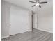 Bedroom featuring ceiling fan, gray wood-look floors, and large closet at 18868 E Canary Way, Queen Creek, AZ 85142