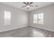 Bright bedroom with wood-look floors, ceiling fan, and natural light at 18868 E Canary Way, Queen Creek, AZ 85142