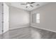 Bedroom featuring wood floors, ceiling fan, window and neutral colored walls at 18868 E Canary Way, Queen Creek, AZ 85142