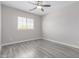 Bedroom featuring wood floors, ceiling fan and window at 18868 E Canary Way, Queen Creek, AZ 85142