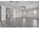 Large bonus room featuring wood-look floors, ceiling fan, and natural light at 18868 E Canary Way, Queen Creek, AZ 85142