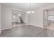 Open dining room with wood flooring, chandelier, adjacent to the staircase and plenty of natural light at 18868 E Canary Way, Queen Creek, AZ 85142