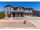 Charming two-story home with a well-manicured front yard and attached two-car garage, painted in neutral gray tones at 18868 E Canary Way, Queen Creek, AZ 85142