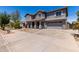 Inviting two-story home with a covered porch, attached garage, and mature trees at 18868 E Canary Way, Queen Creek, AZ 85142