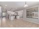 Kitchen with stainless steel appliances, an island and white cabinetry, bathed in natural light at 18868 E Canary Way, Queen Creek, AZ 85142